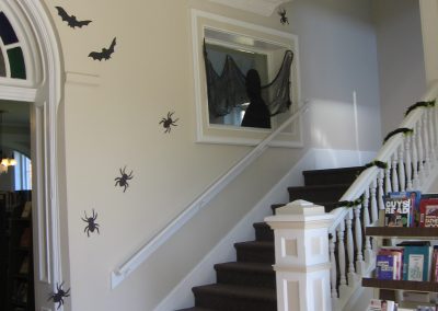 A stairway in the library decorated with spiders and bats for Halloween.